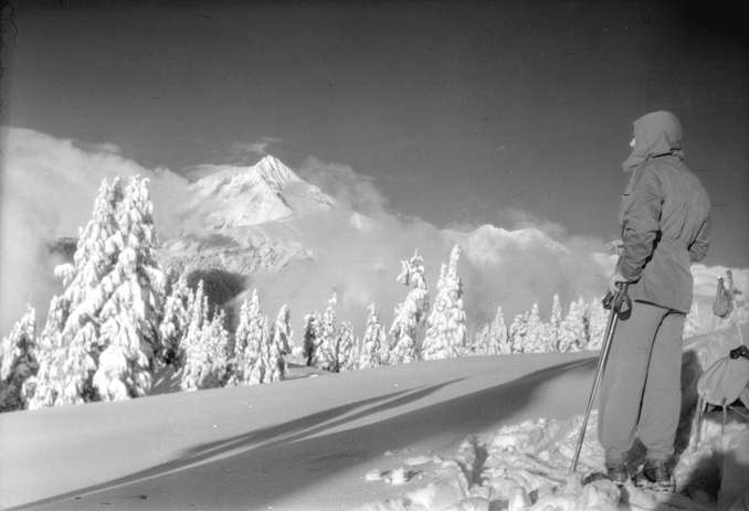 1945-A skier looks towards Mount Garibaldi from the trail leading to Garibaldi Hostels winter camp