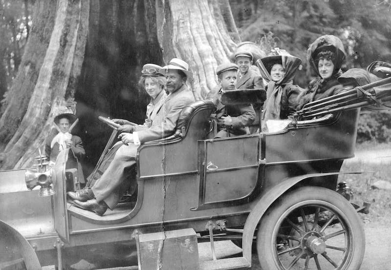 1905-A group in a car in front of the Hollow Tree at Stanley Park