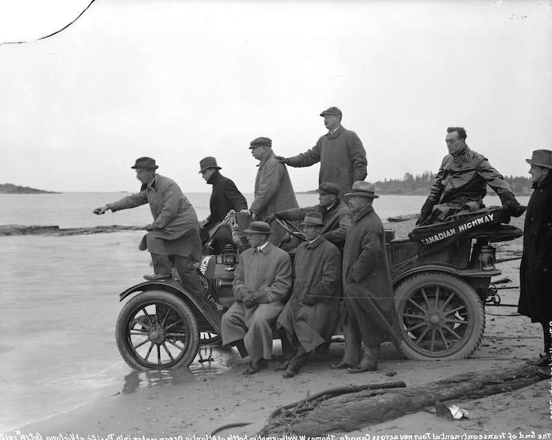 1912-Thomas W. Wilby emptying a bottle of Atlantic Ocean water into Pacific Ocean at the end of his trip across Canada by car