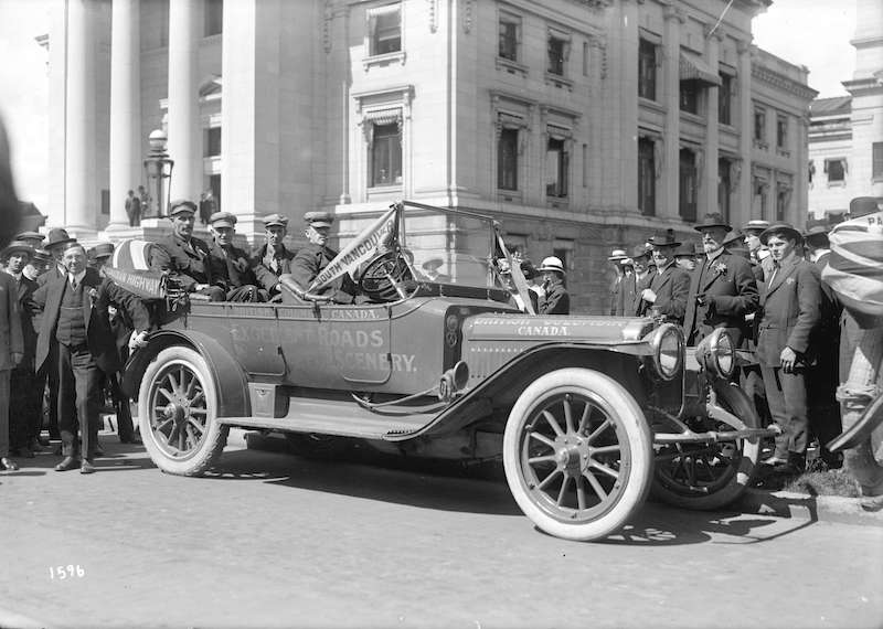 1918-Mayor Gale and other dignitaries assembled around car decorated for the campaign to build the Trans Canada Highway
