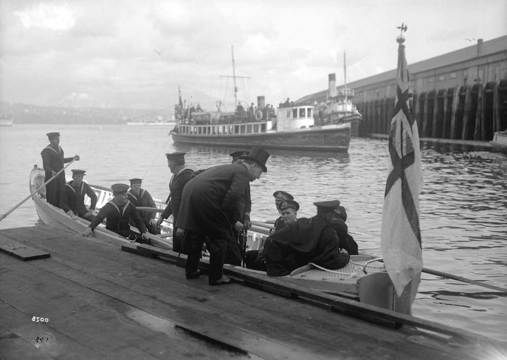 1920-Open boat from naval vessel with crewmen and passenger at dockside - Vancouver harbour