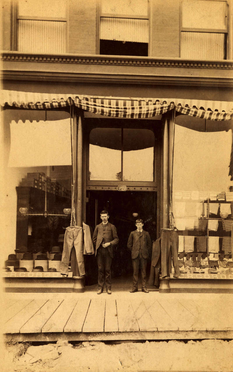 1890-George Robertson Gordon in front of his mens' wear store at 107 Carroll Street