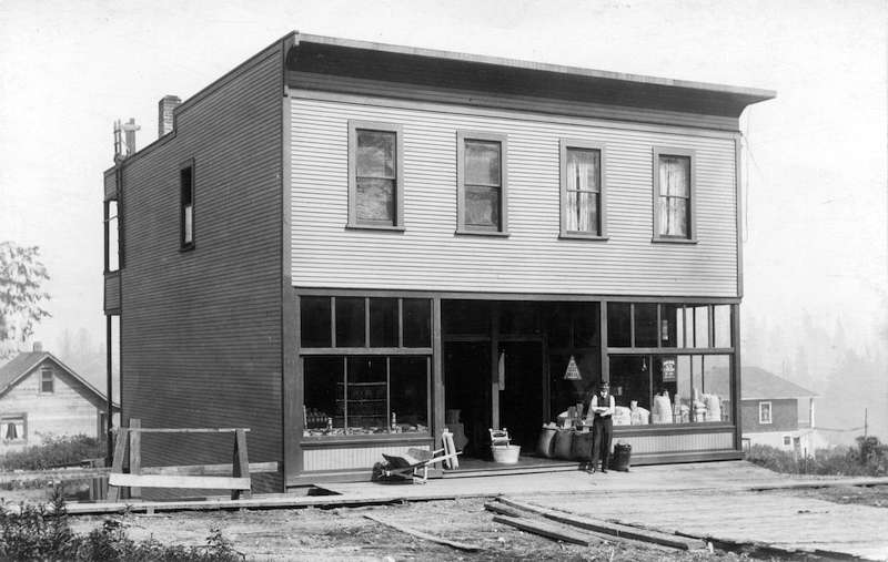 1910?-Hansford James Edwards in front of his store at 524 Renfrew Street