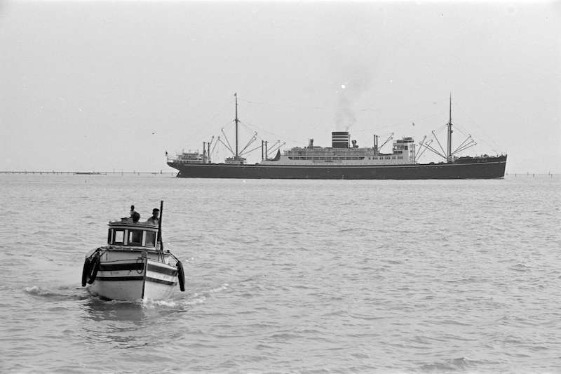 1938 - A fishing boat and a freighter