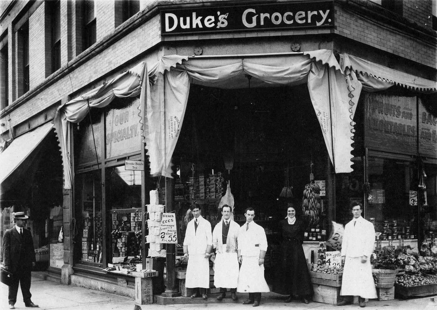 1911 - Duke's Grocery staff posing in front of store at the comer of Gore Avenue and Hastings Street