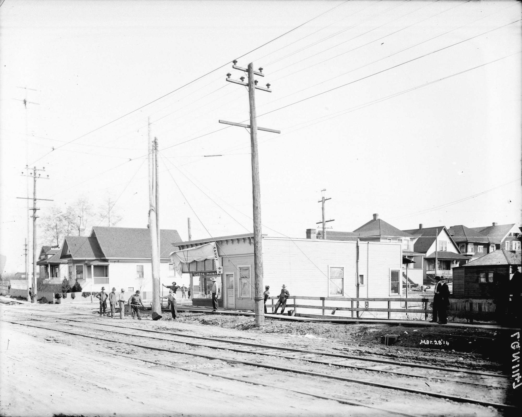 1914 - Men erecting power pole at Commercial Drive and Eleventh Avenue