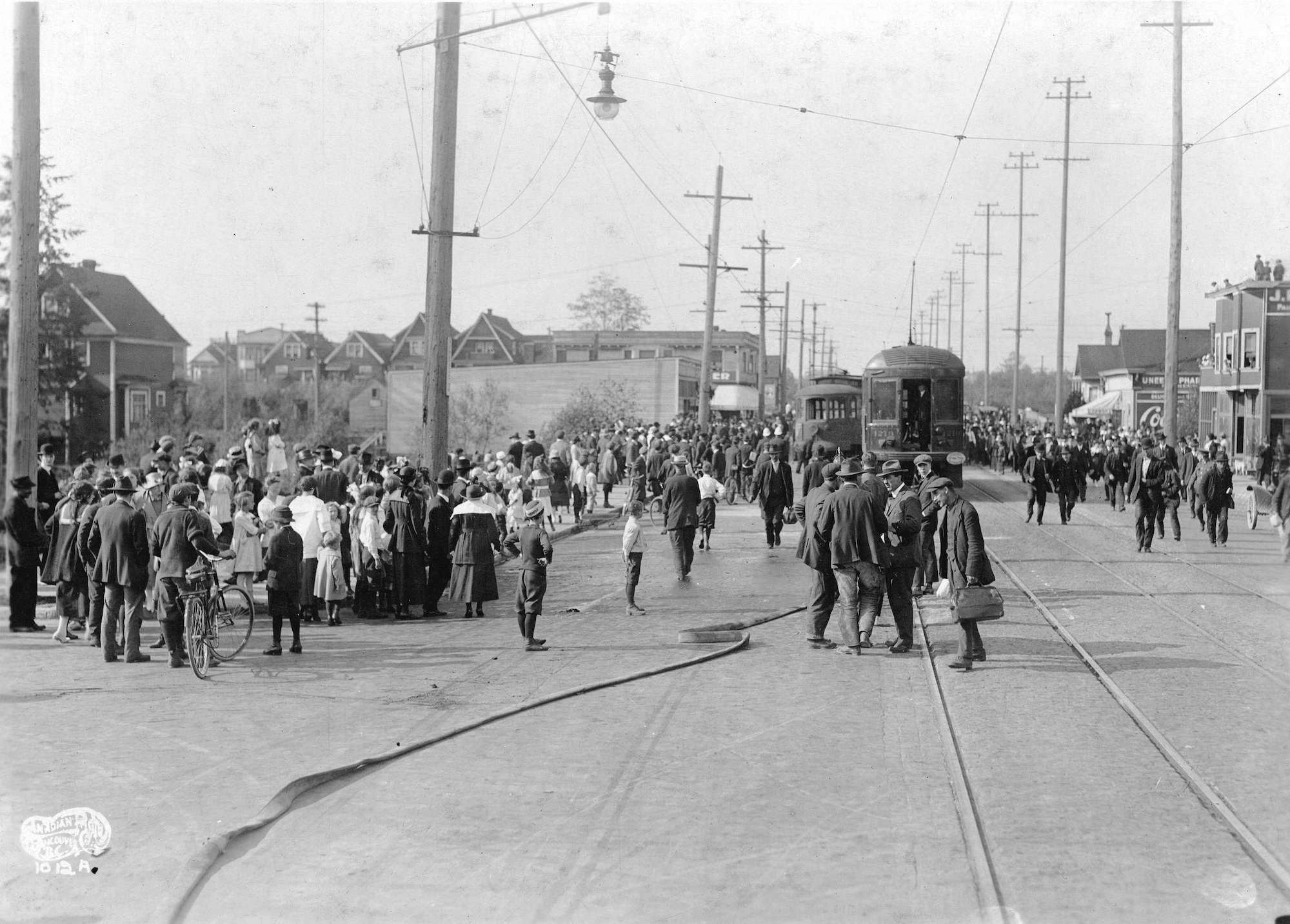 1918 - Crowds gather after a streetcar was derailed by the No. 11 V.F.D. hosewagon at 12th Avenue and Commercial Drive