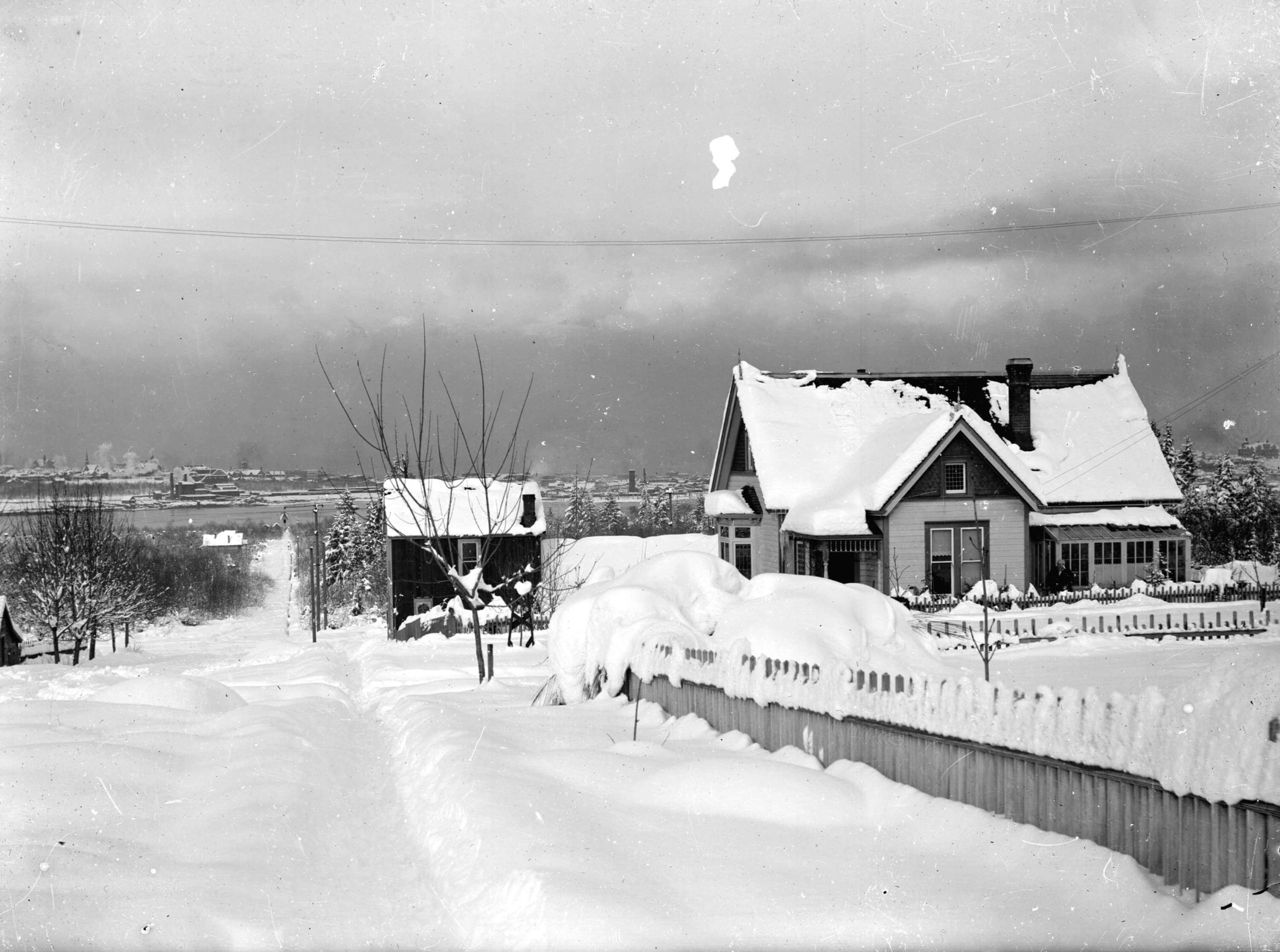 1900 - View of house at 2532 Columbia Street at 10th Avenue, covered in snow