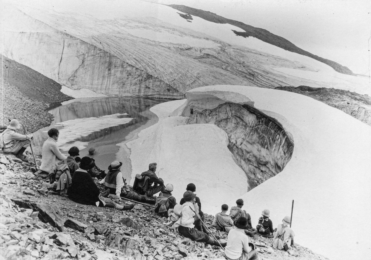 1920? - A group of hikers resting beside a glacier
