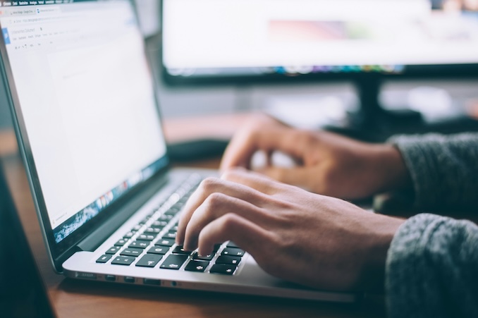 Guy using a keyboard at a desk.