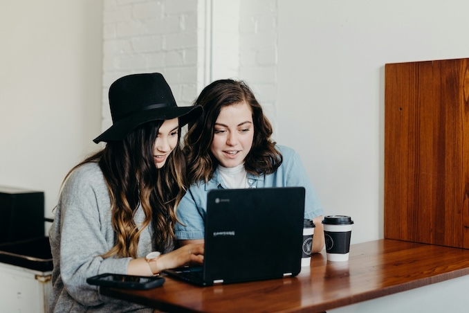 women using a laptop at a desk.