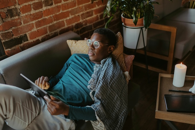 Man using a tablet on the couch.