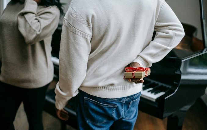 guy holding a present behind his back