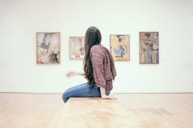 Woman looking at art