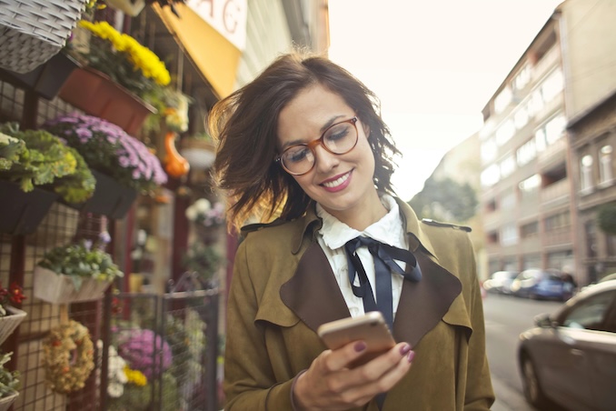 Woman using a cell phone and smiling